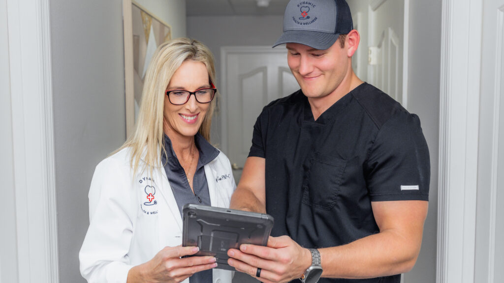 Wendy Clow, a functional medicine nurse practitioner near Leesburg reviewing a patient's medical history with a member of the Dynamic Health & Wellness team.