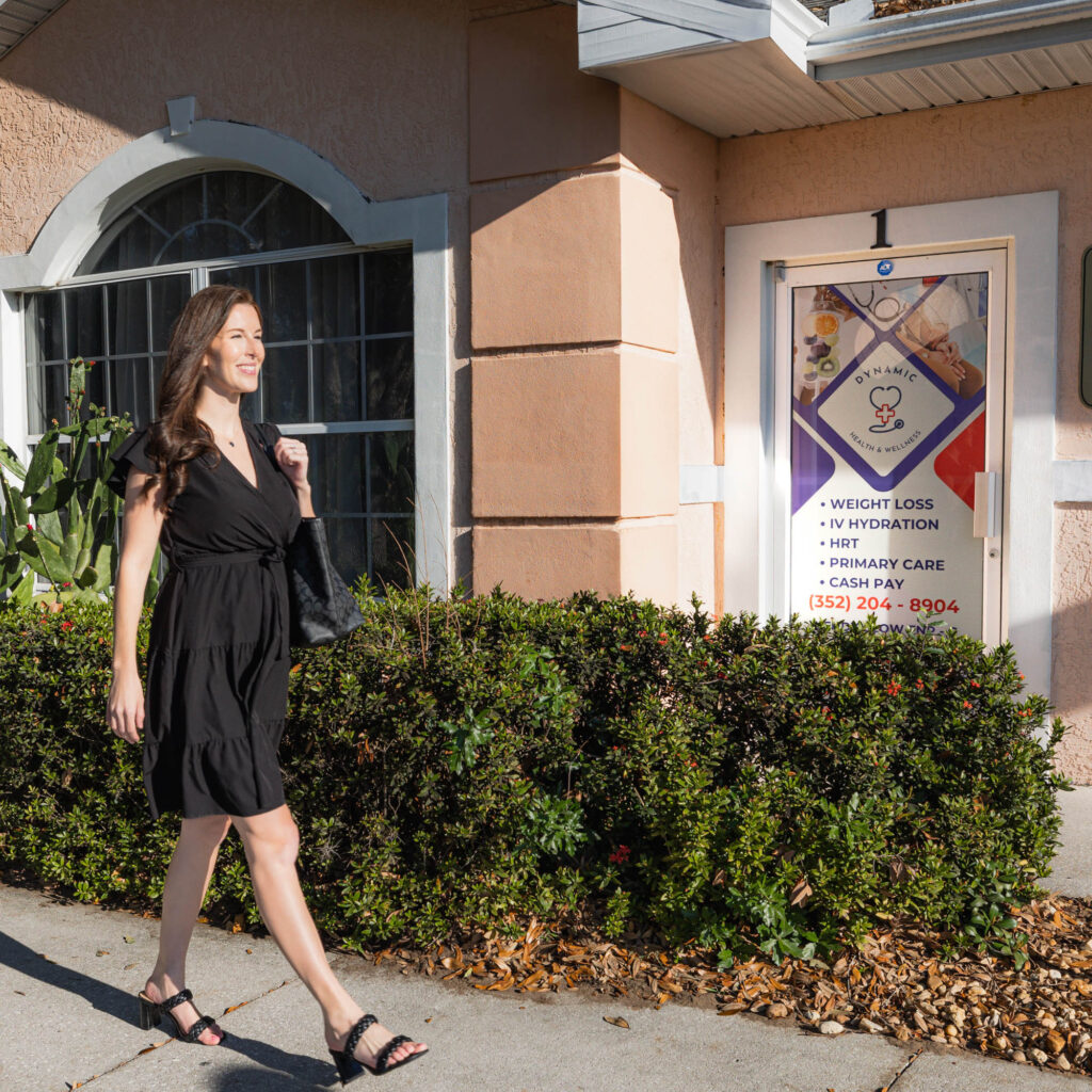 Woman confidently walking into a primary care clinic and med spa where they offer weight loss programs in Leesburg.